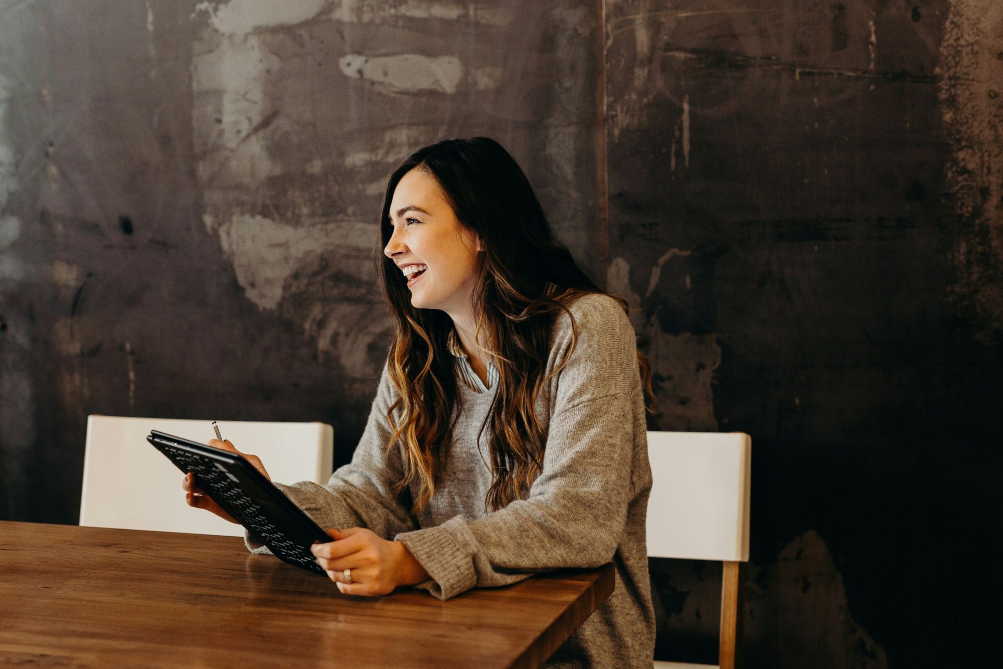 A woman enjoying work on her tablet